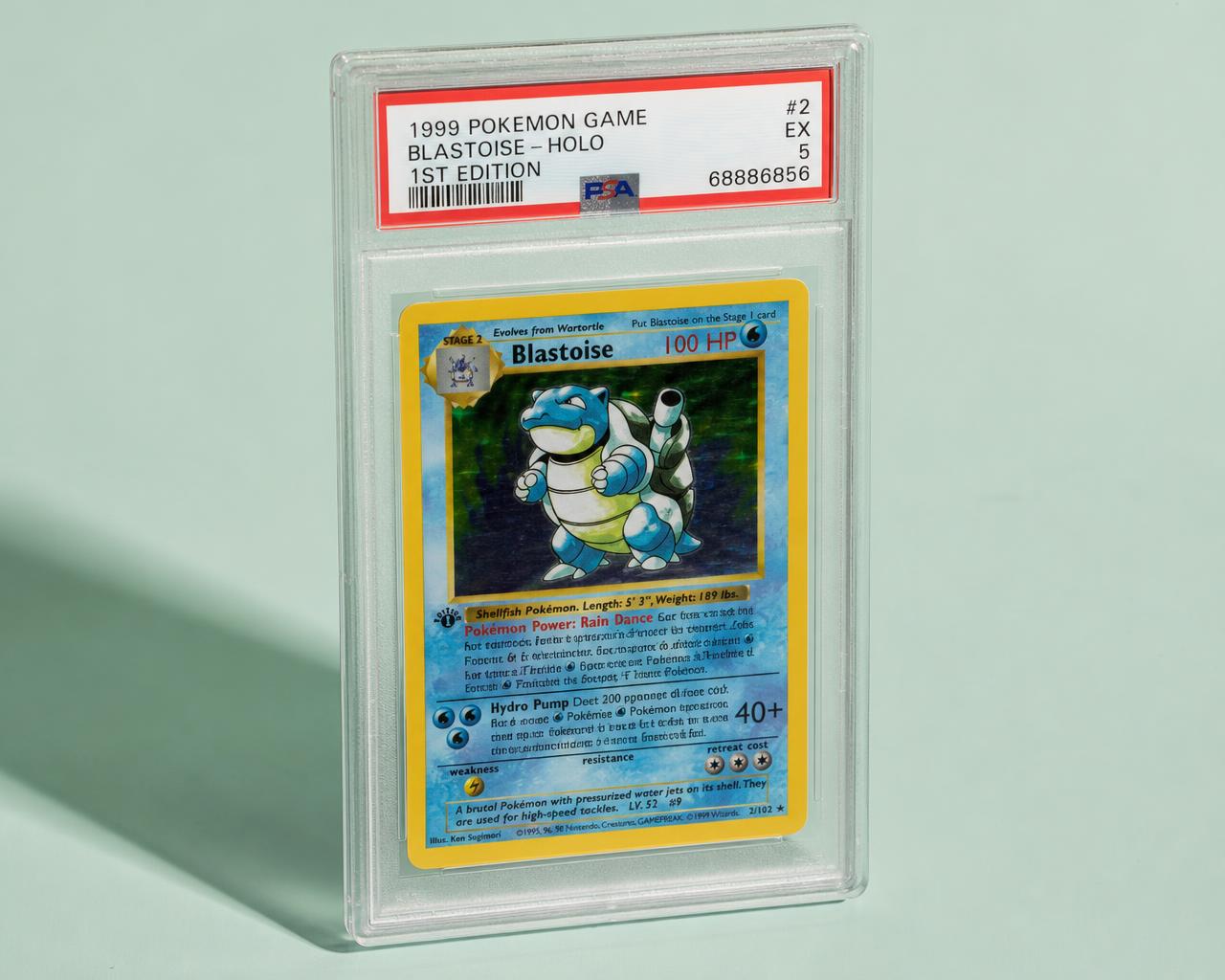 Single graded trading card slab resting on a pale studio surface